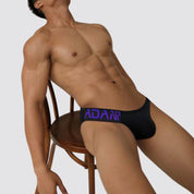 Adannu men's low-waist hip briefs in black with purple waistband, showcasing a sleek fit and supportive front pouch.