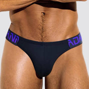 Close-up of Adannu black low-waist hip briefs with purple waistband, emphasizing the supportive front pouch.