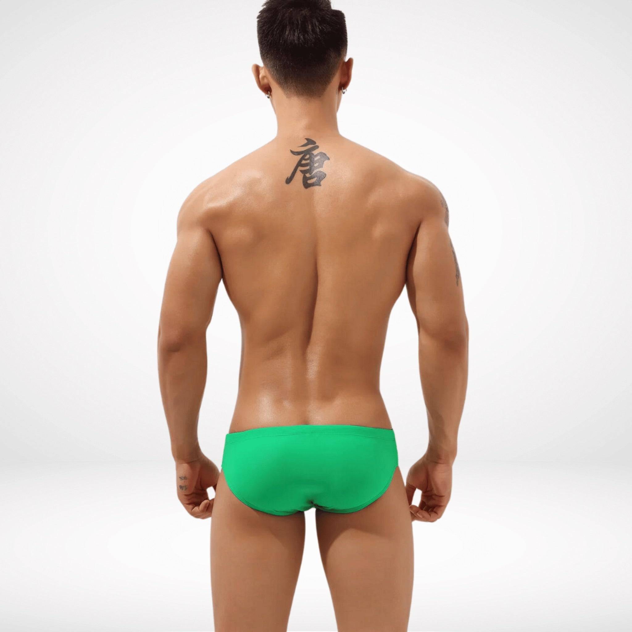 Rear view of green Aura Cutout Swim Briefs with a smooth and comfortable fit, perfect for beach or poolside wear.