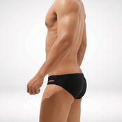 Side view of black Aura Cutout Swim Briefs showcasing the cutout accents and modern fit for a bold swimwear statement.