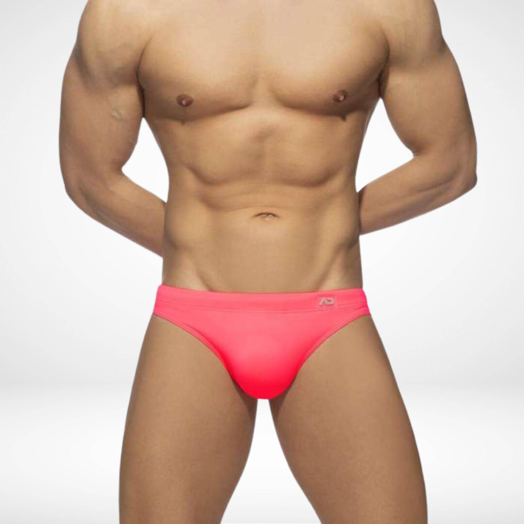 Men's pink quick-dry swim briefs with a bold, stylish design, offering a secure fit and removable pad for versatile swimwear.