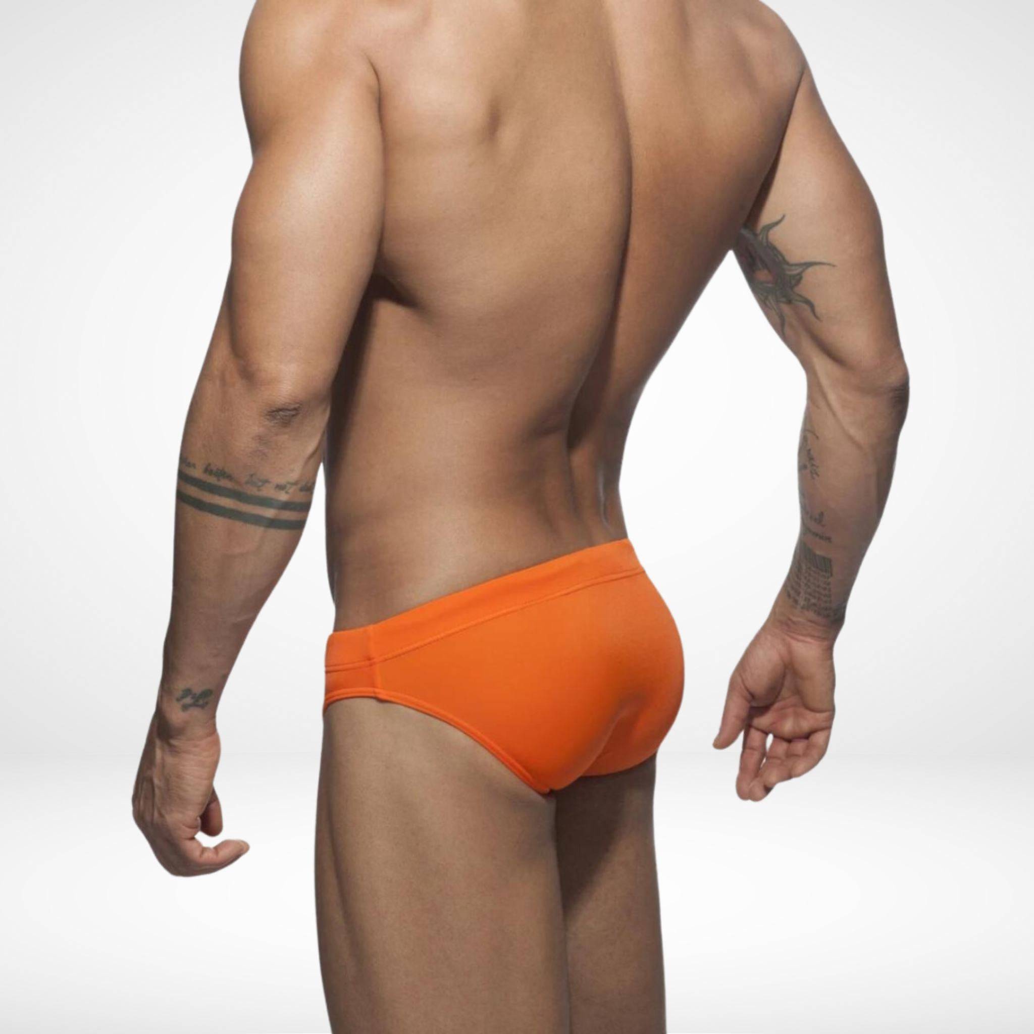 Back view of men's orange swim briefs featuring a snug fit and durable fabric, perfect for beach and pool activities.