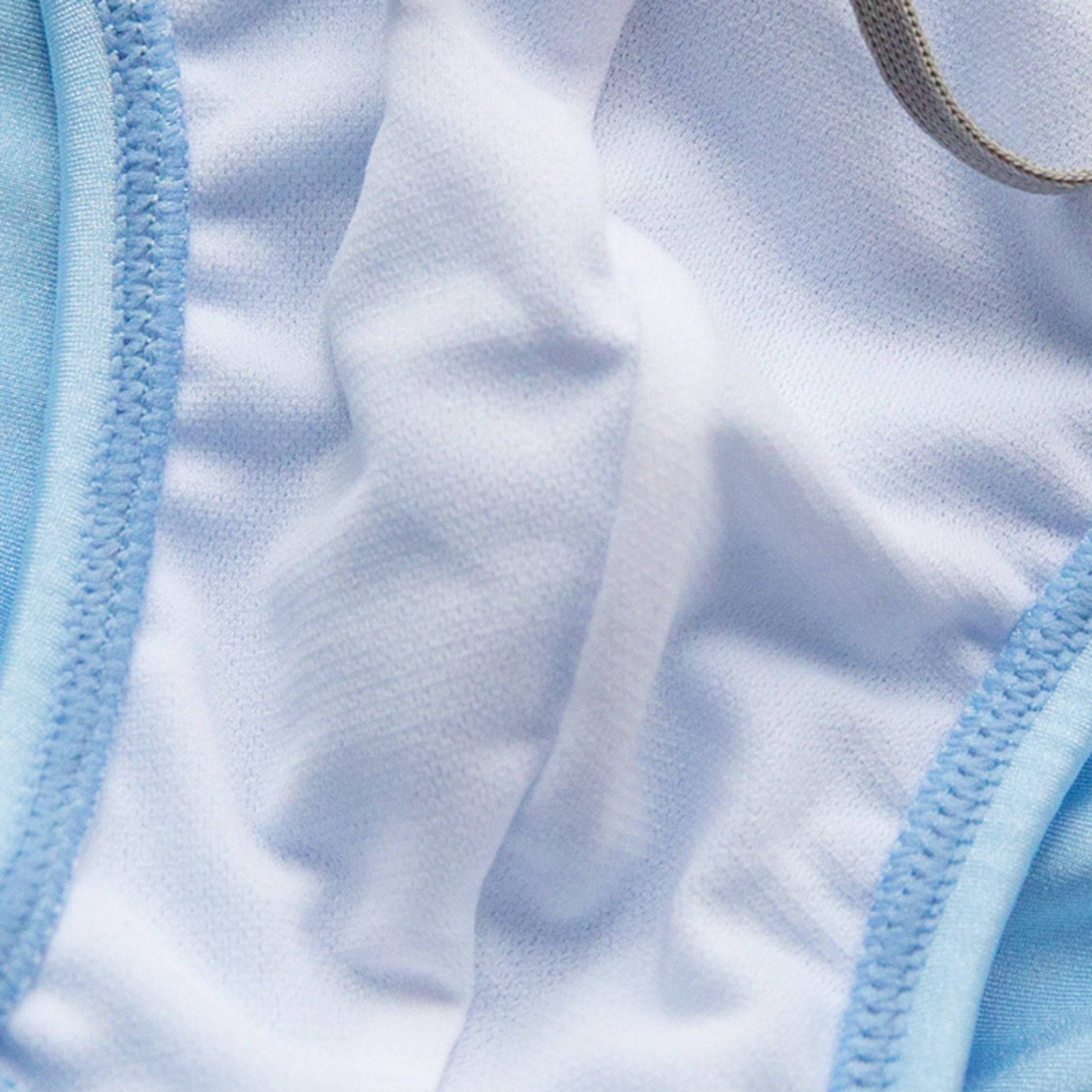 Interior view of men's light blue bikini swim briefs, highlighting the soft lining and reinforced stitching for added comfort and durability.