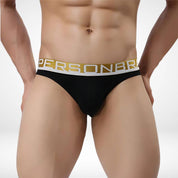 Front view of black Brave Person men's briefs with supportive pouch and gold waistband, combining style and functionality.