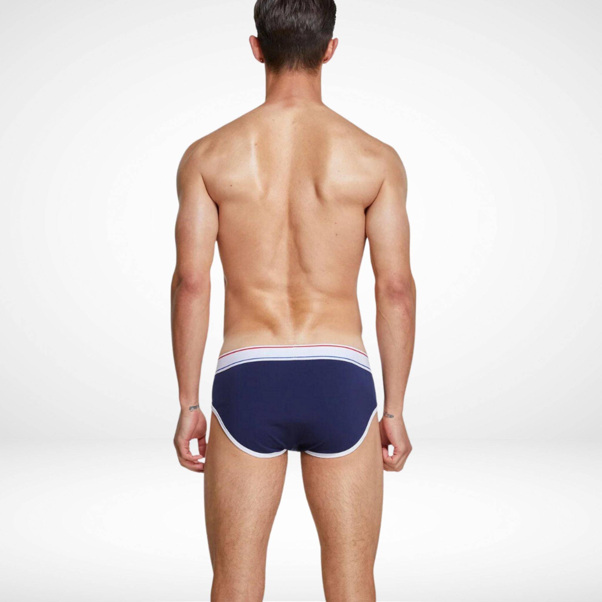 Back view of navy breathable cotton stretch briefs for men with white contrast piping and a flexible waistband.