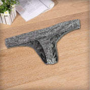 Flat-lay of gray breathable soft thong underwear for men, featuring a soft fabric blend and ergonomic design.