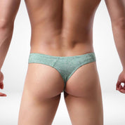 Back view of green breathable soft thong underwear for men, highlighting the thong style and comfortable waistband.