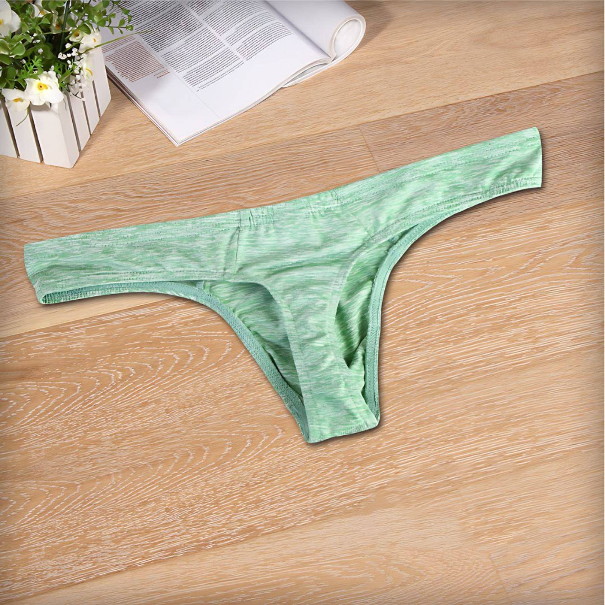 Flat-lay of green breathable soft thong underwear for men, showcasing its soft fabric and ergonomic design for comfort.