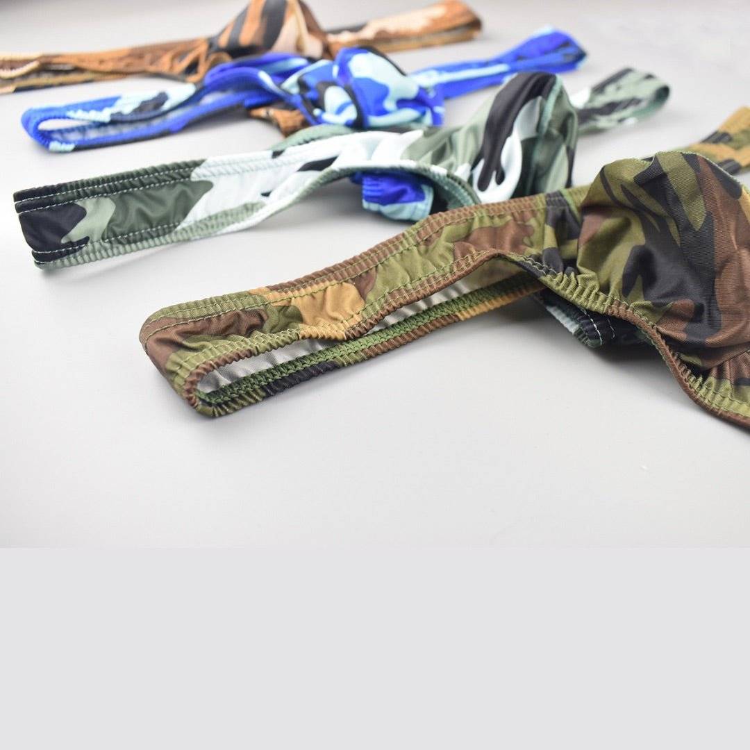 Assorted camo thongs in various colors, featuring comfort fit bulge pouches and fade-resistant, lightweight fabric.