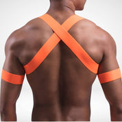 Back view of men's orange neon circuit party harness with crisscross straps and matching arm bands, ideal for circuit events.