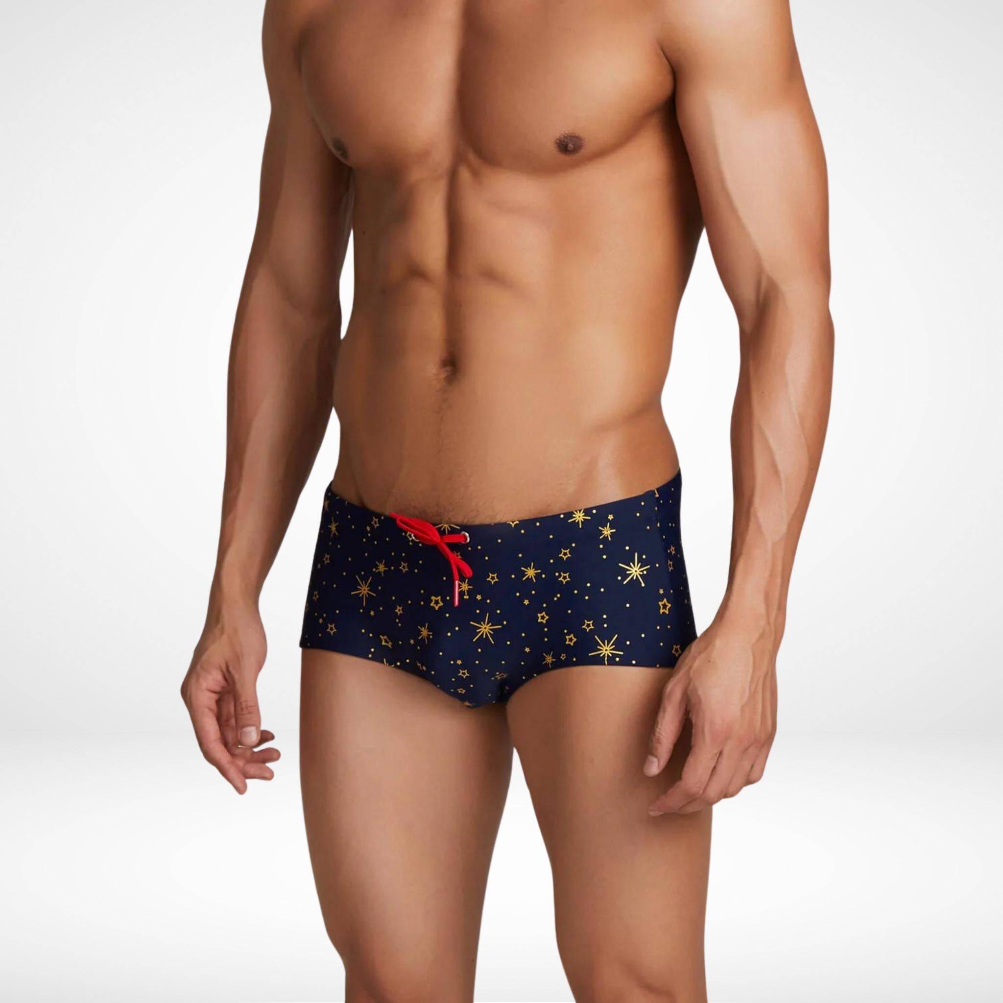 Men's gold star swim trunks with a quick-dry fabric, featuring a fitted design, bold star pattern, and red drawstring in a front-side view.