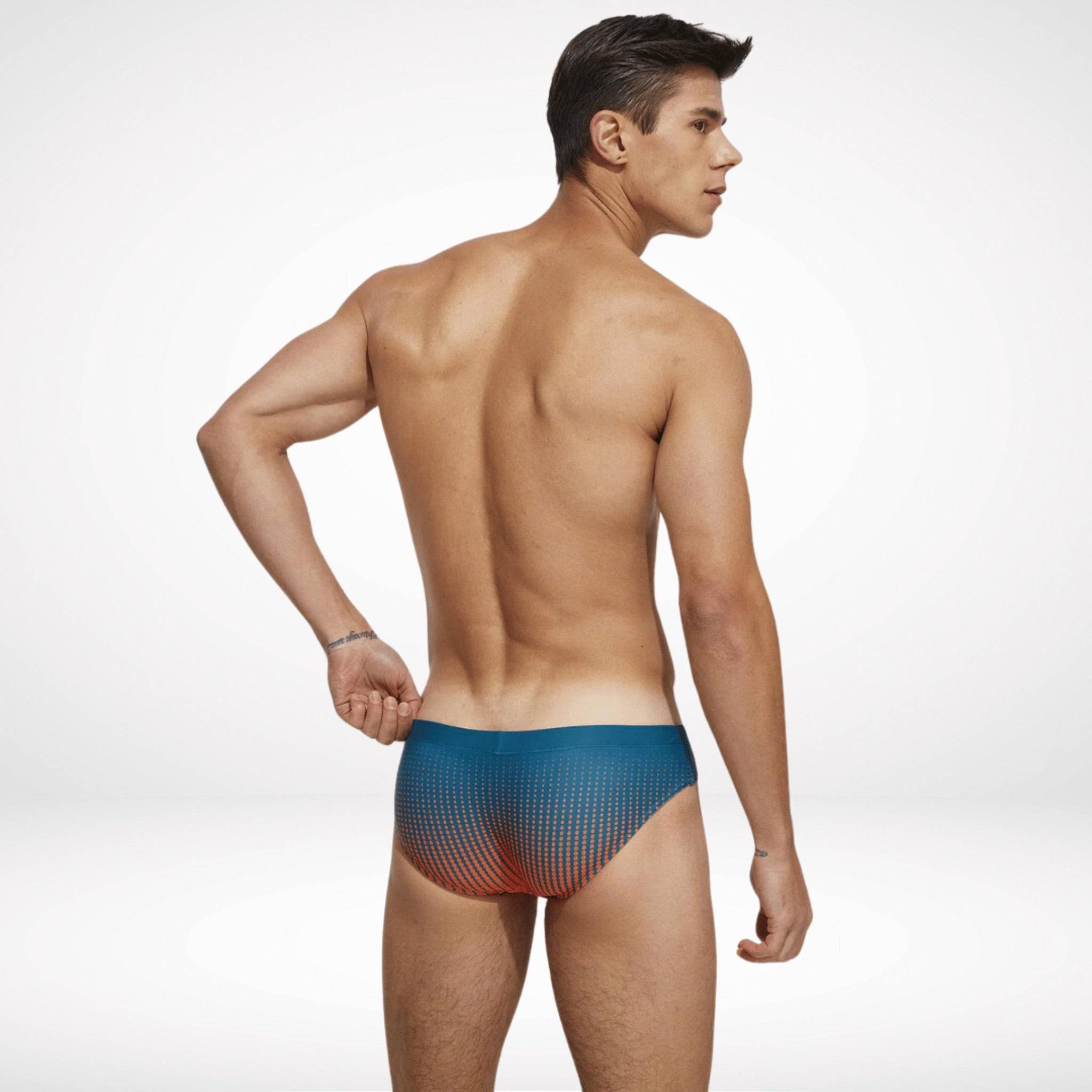 Back view of men's gradient swim briefs in teal and orange, featuring a snug fit and bold gradient design for active swimwear.