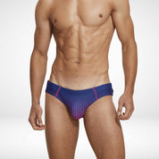 Close-up front view of men's gradient swim briefs in navy and pink, featuring quick-dry material and a sleek, low-rise fit.