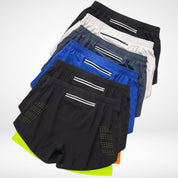 Top view of METCON workout shorts in multiple colors, showcasing zippered back pockets and laser-cut ventilation for activewear.