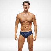 Men's navy blue swim briefs with palm tree design, featuring a quick-dry and stretchy fit. Ideal swimwear for beach or pool activities.