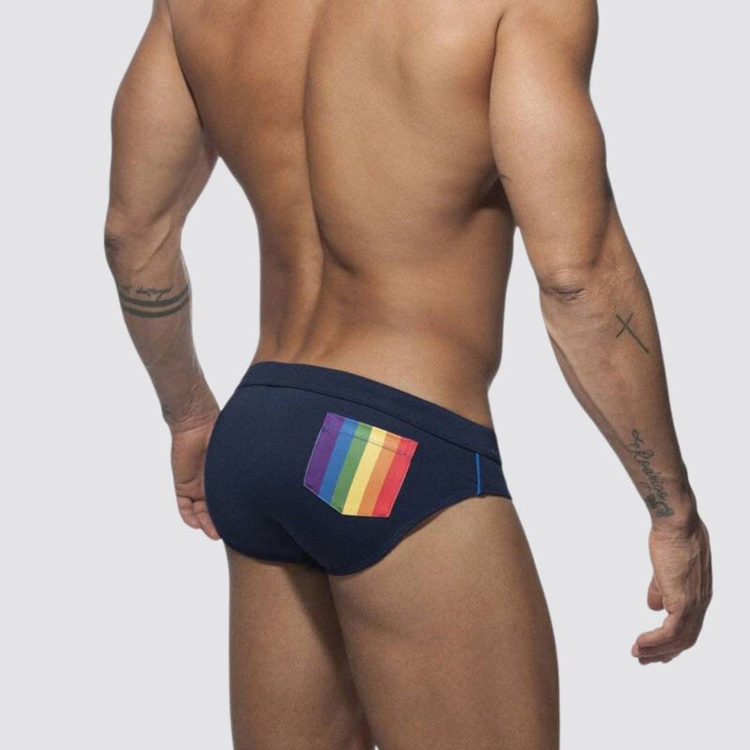 Back view of navy swim briefs with a colorful rainbow pocket, designed for quick-dry performance and style.