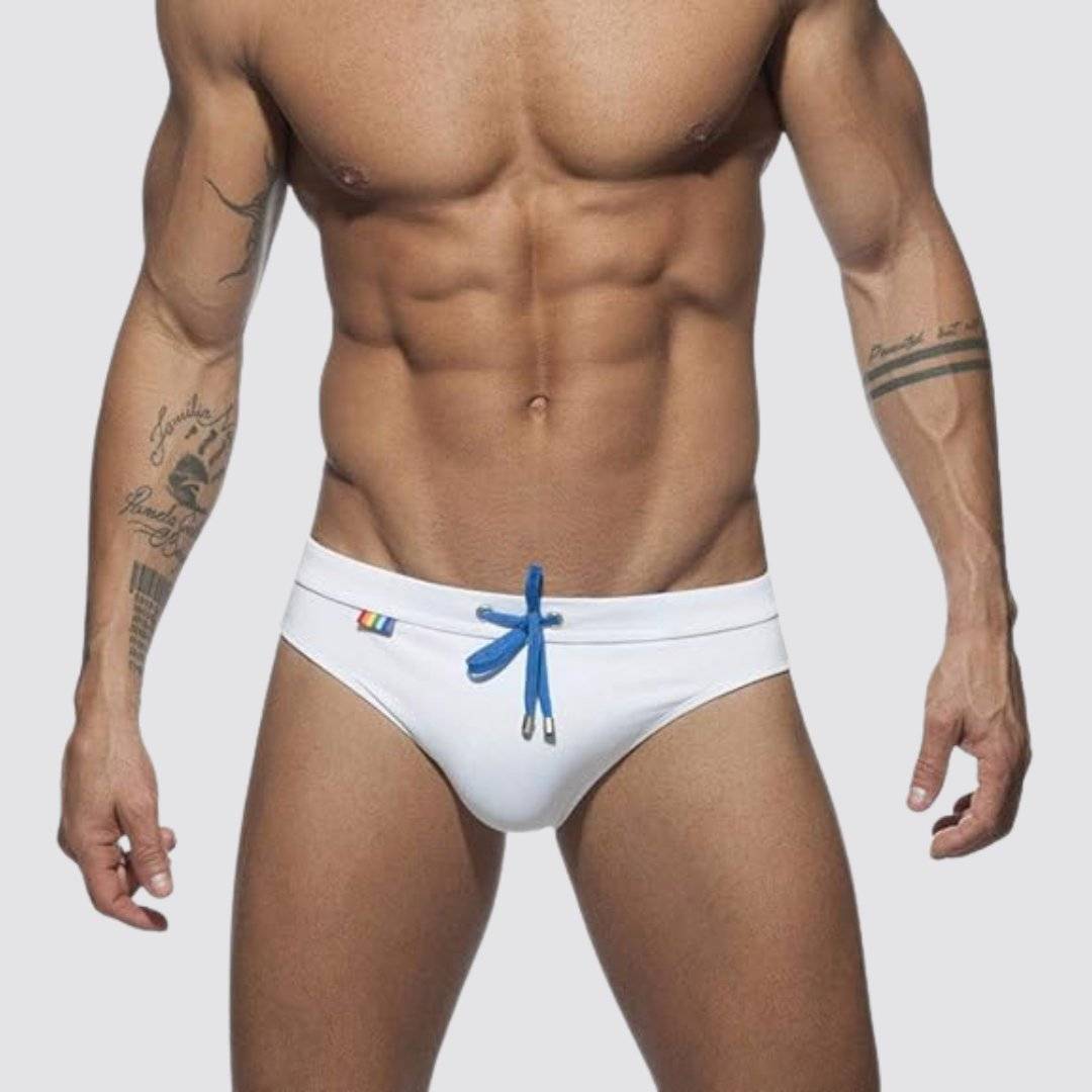 Front view of white swim briefs with blue drawstring and rainbow detailing, designed for quick-dry performance.