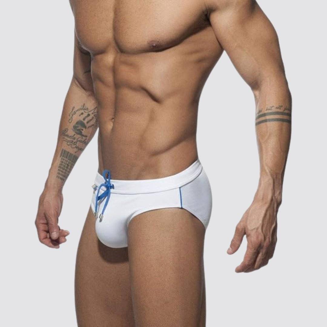 Men's white swim briefs with blue drawstring and rainbow detailing, offering a sleek and modern fit.