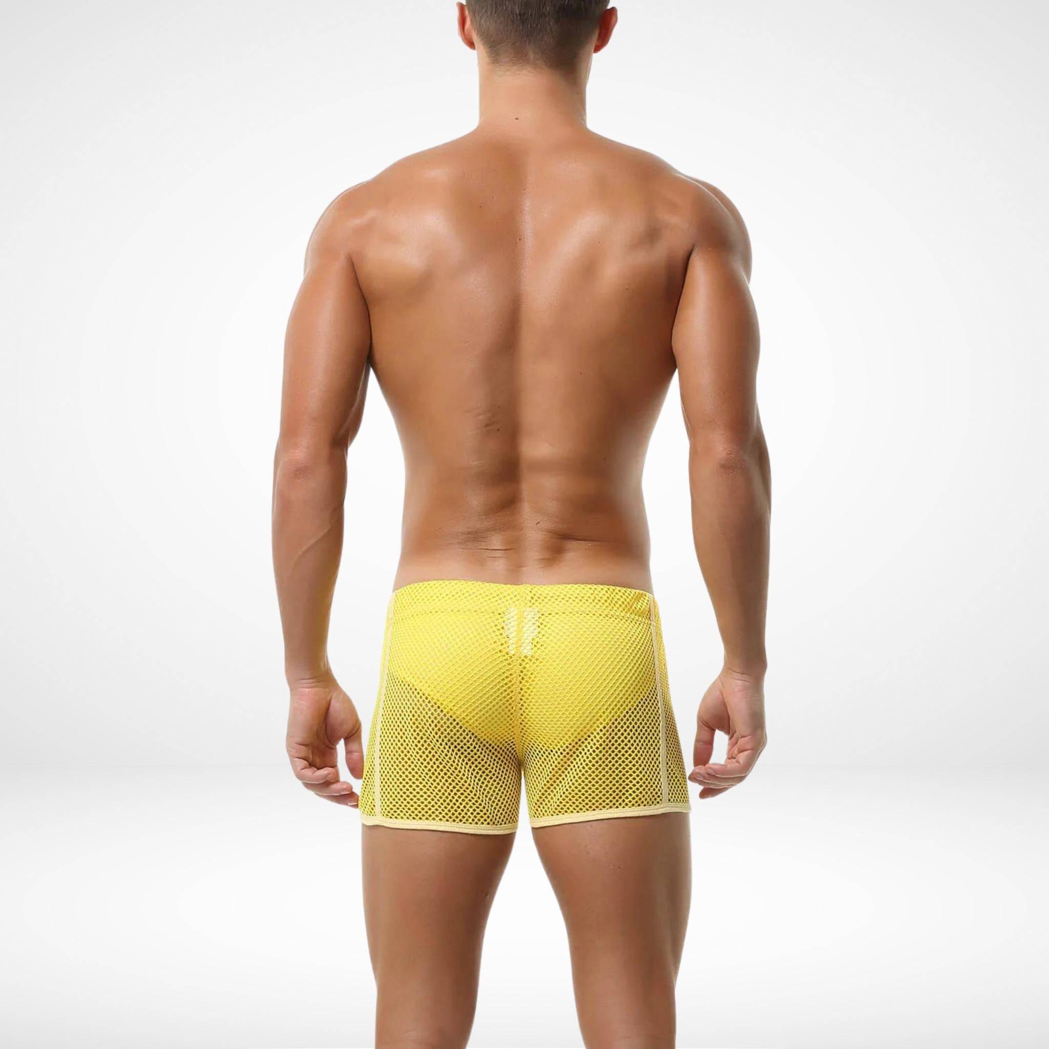 Back view of yellow men's mesh pool and beach shorts showcasing breathable material and comfortable fit for swim and beach activities.