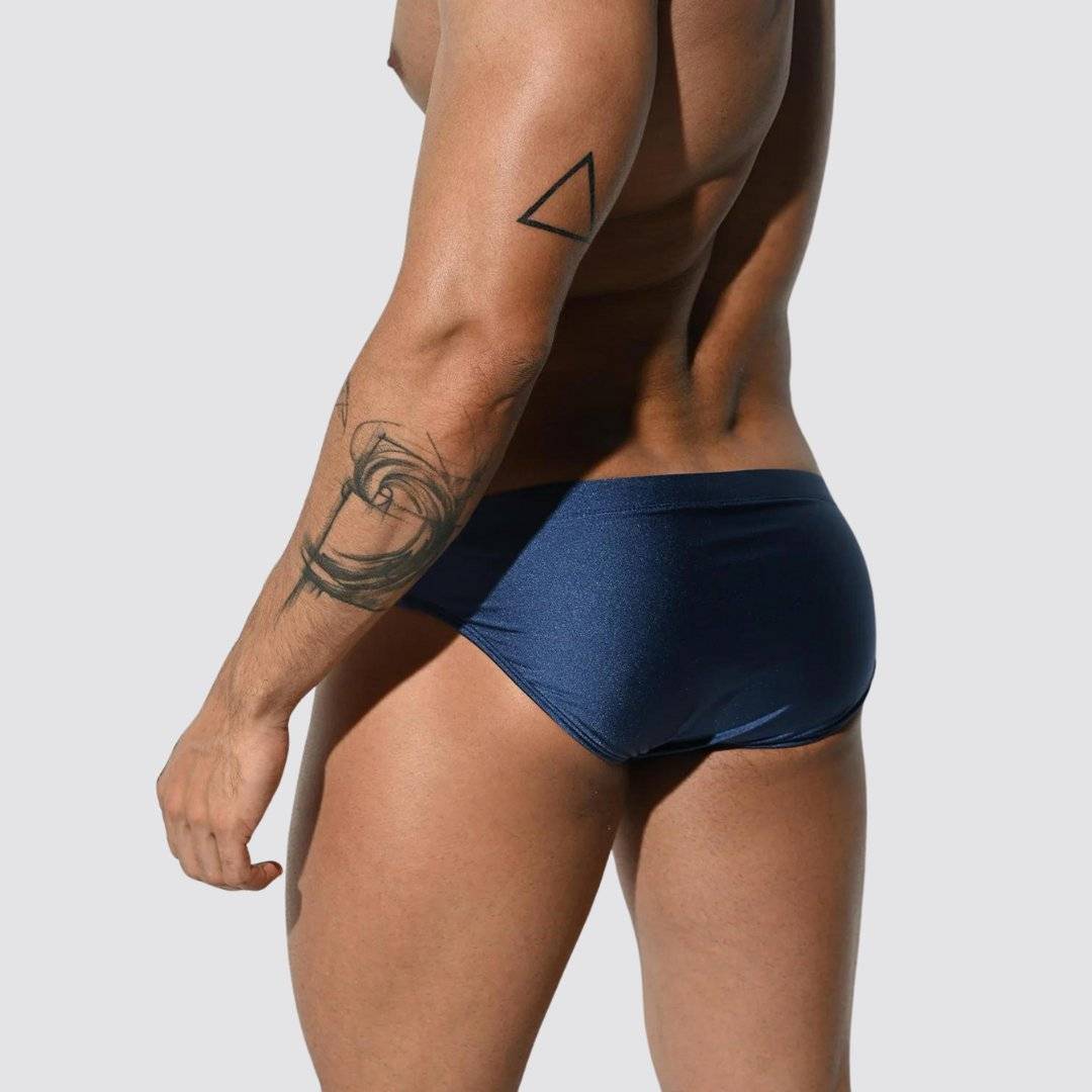 Men's shimmer low rise swim briefs in navy blue, back view highlighting a snug fit and smooth, stretchy material.