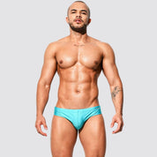 Men's shimmer low rise swim briefs in turquoise, front view featuring a stylish speedo fit and comfortable nylon-spandex blend.