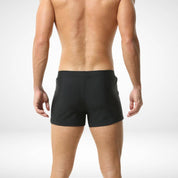 Back view of men's black square cut swim trunks showcasing a streamlined fit and smooth fabric for a stylish swimwear option.