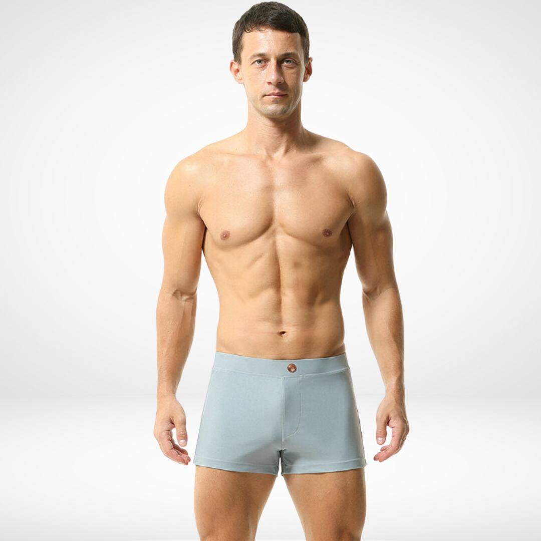 Men's light gray square cut swim trunks with a snug fit, crafted from quick-dry fabric for a sleek and comfortable swimwear option.