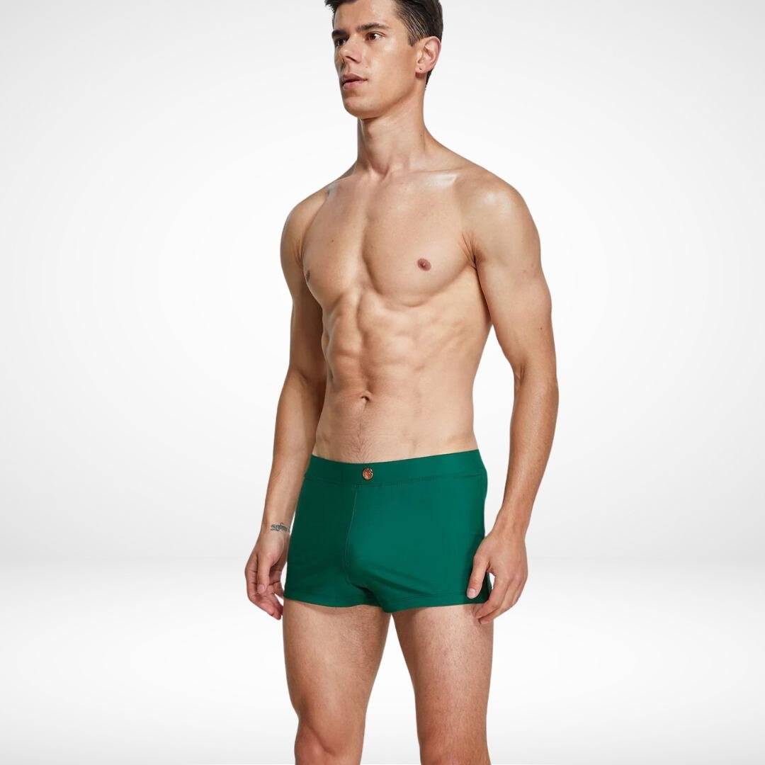 Men's green square cut swim trunks with a snug fit, crafted from quick-dry fabric for a sleek and comfortable swimwear option.