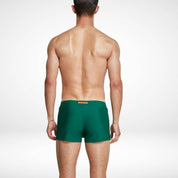 Back view of men's green square cut swim trunks, highlighting the smooth and streamlined design for a modern swimwear style.