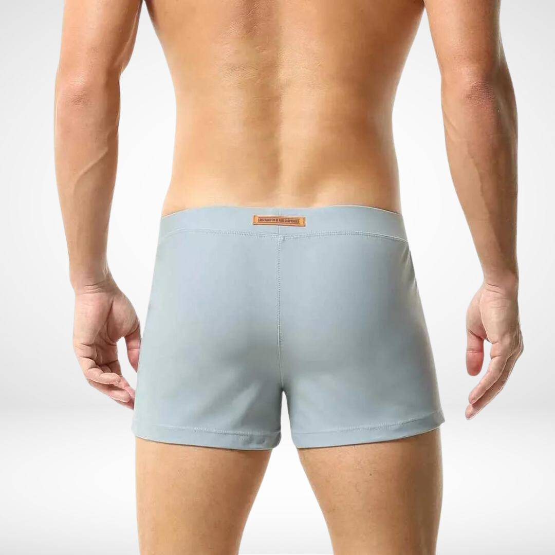 Back view of men's light gray square cut swim trunks, highlighting the smooth and streamlined design for a modern swimwear style.