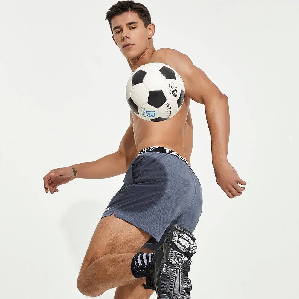 Gray men's lined gym training shorts with a Tauwell branded waistband, displayed in an athletic pose for versatile workout use.