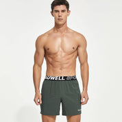 Front view of green men's lined gym training shorts with a Tauwell branded waistband, offering moisture-wicking and quick-dry comfort.