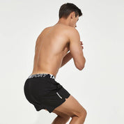 Back view of black men's lined gym training shorts with a Tauwell branded waistband, showcasing a comfortable and supportive fit.