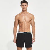 Front view of black men's lined gym training shorts with a Tauwell branded waistband, designed for moisture-wicking and flexibility.