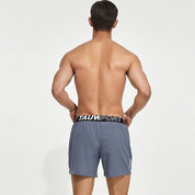 Back view of gray men's lined gym training shorts with a Tauwell branded waistband, highlighting a breathable and flexible design.