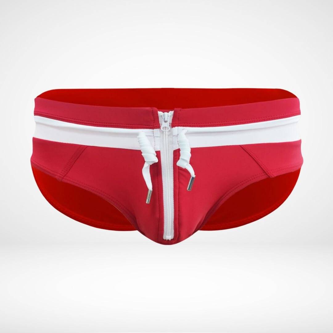 Close-up of red and white zipper front swim briefs with a white zipper and drawstring, emphasizing the bold design.