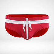 Close-up of red and white zipper front swim briefs with a white zipper and drawstring, emphasizing the bold design.