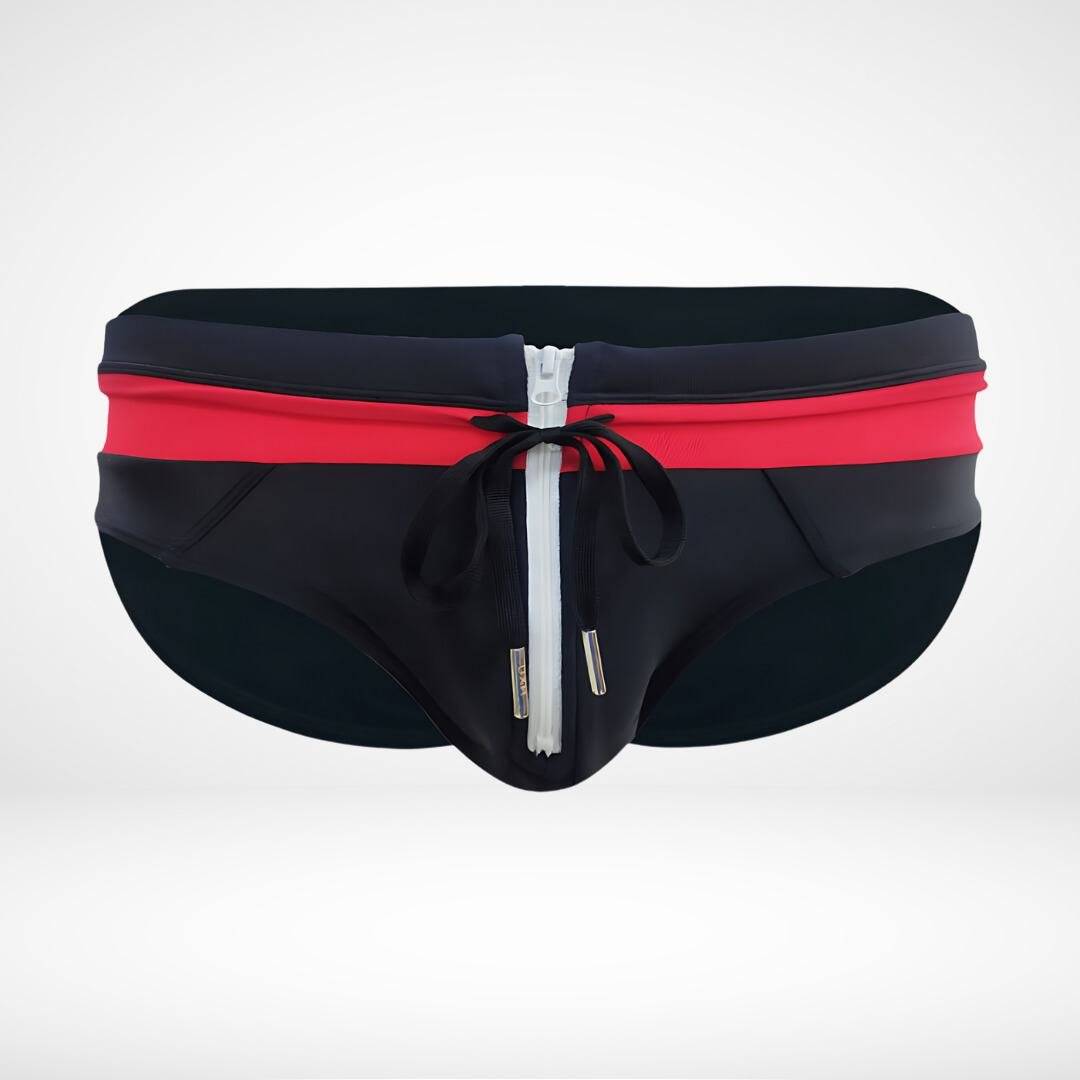 Close-up of black and red zipper front swim briefs featuring a white zipper and drawstring for a stylish finish.