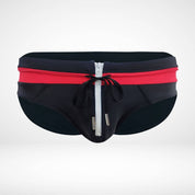 Close-up of black and red zipper front swim briefs featuring a white zipper and drawstring for a stylish finish.