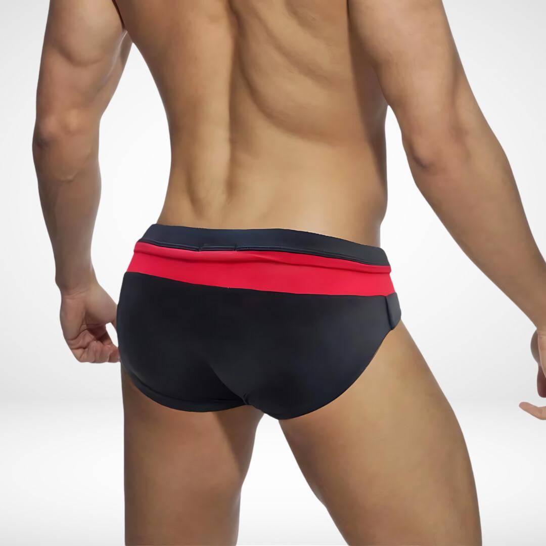 Rear view of black and red zipper front swim briefs, emphasizing the vibrant color contrast and snug fit.